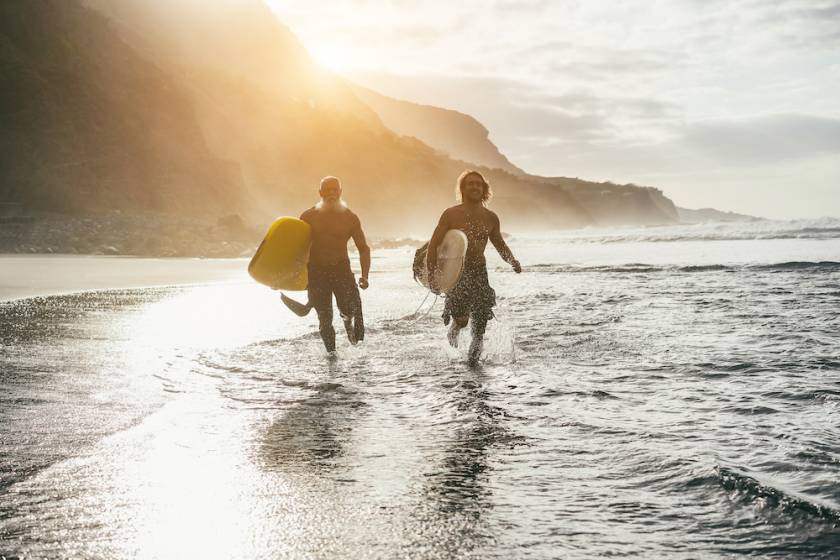 surfing, running on the beach, friends surfing